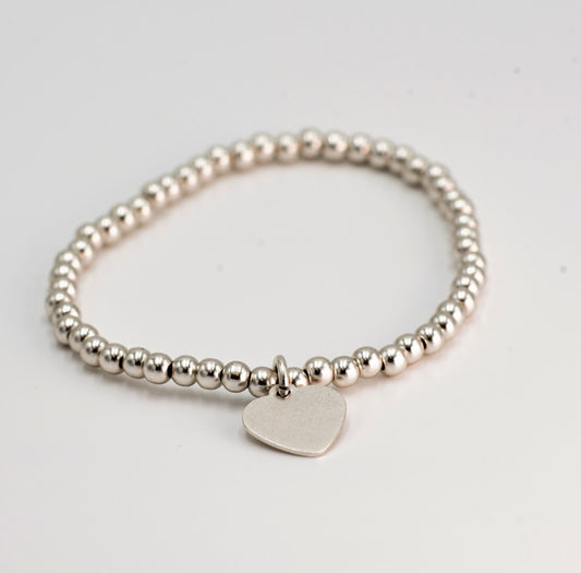 Bracciale elastico con palline piene e charm B00